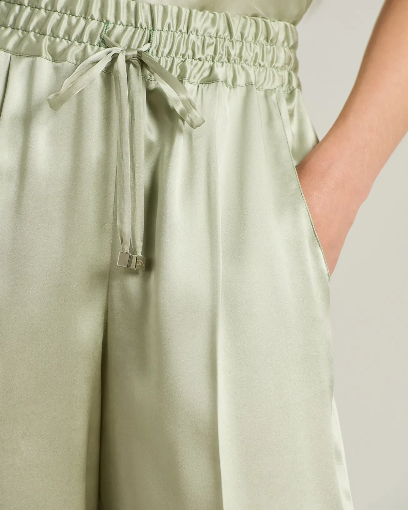 FLUID SATIN TROUSERS IN GREEN SILK